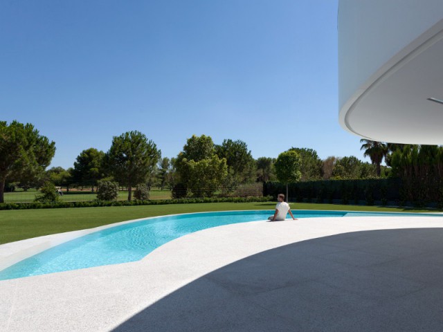 Une piscine aux formes courbes, dans la continuité de la maison - Casa Balint par Fran Silvestre Architectos
