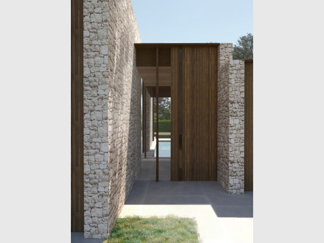 Des murs en pierre pour structurer le bâtiment - Une maison ton sur ton avec le paysage
